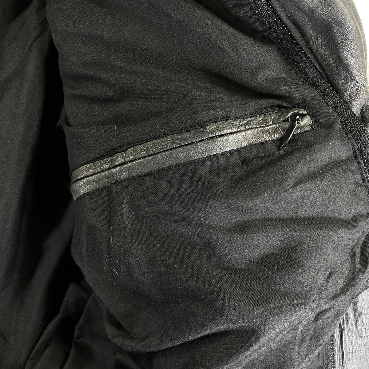 Digg It Thrift & Vintage Lonsdale London leather moto jacket interior showing a black zippered pocket lining