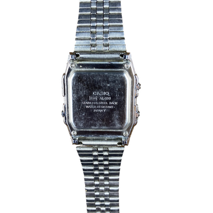 Digg It Thrift & Vintage Casio AL-180 solar watch stainless steel case back view on a textured brown leather surface