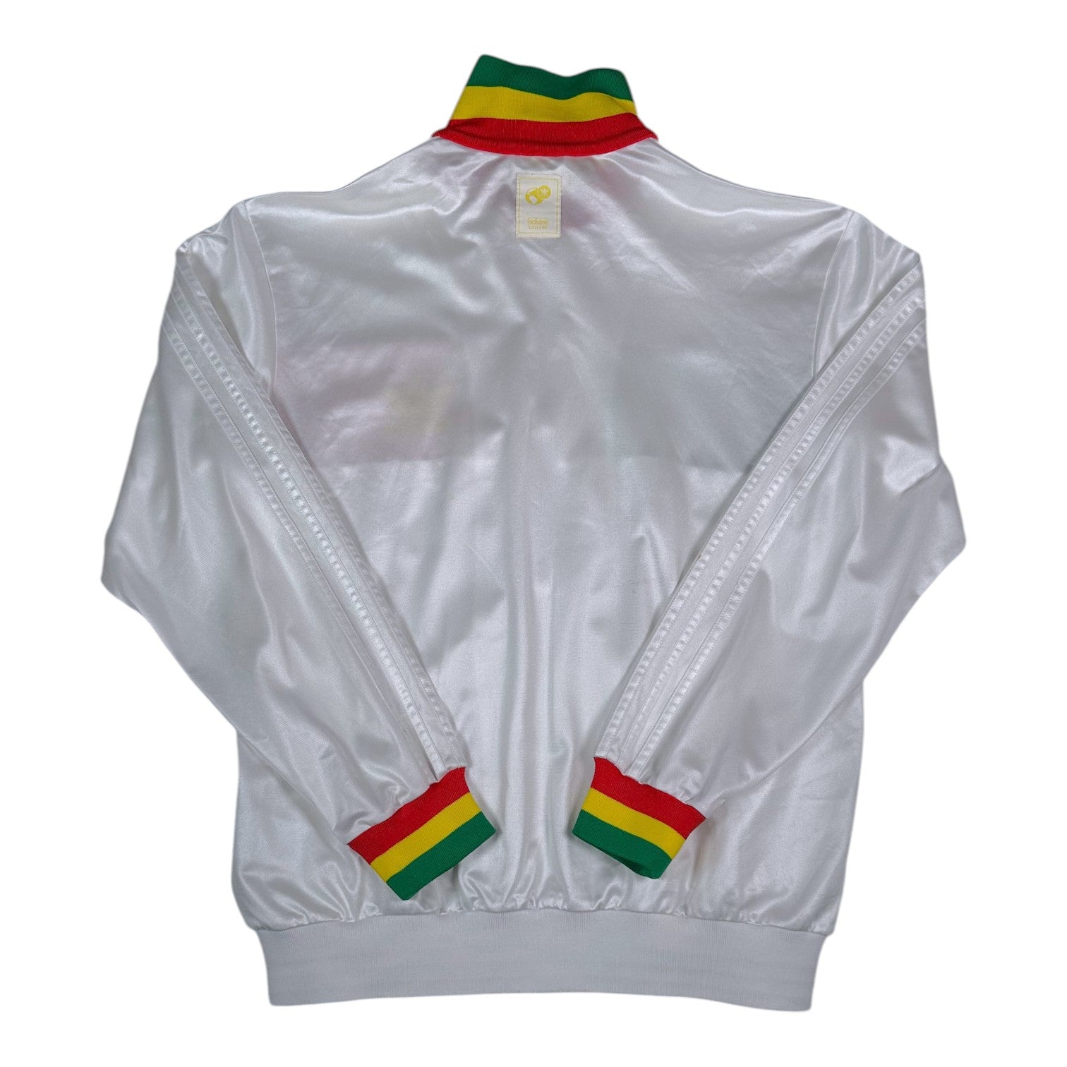 Back view of a white Digg It Thrift & Vintage Adidas Chile track jacket with Rasta-colored collar and cuffs.