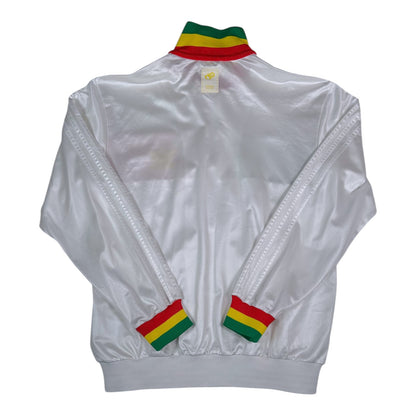 Back view of a white Digg It Thrift & Vintage Adidas Chile track jacket with Rasta-colored collar and cuffs.