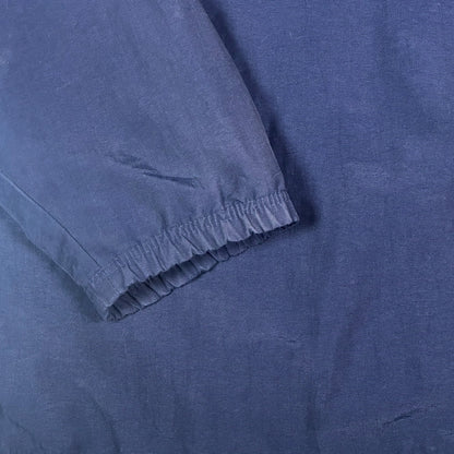 Close-up of navy blue fabric sleeve with elastic cuff from a Digg It Thrift & Vintage Adidas coach jacket