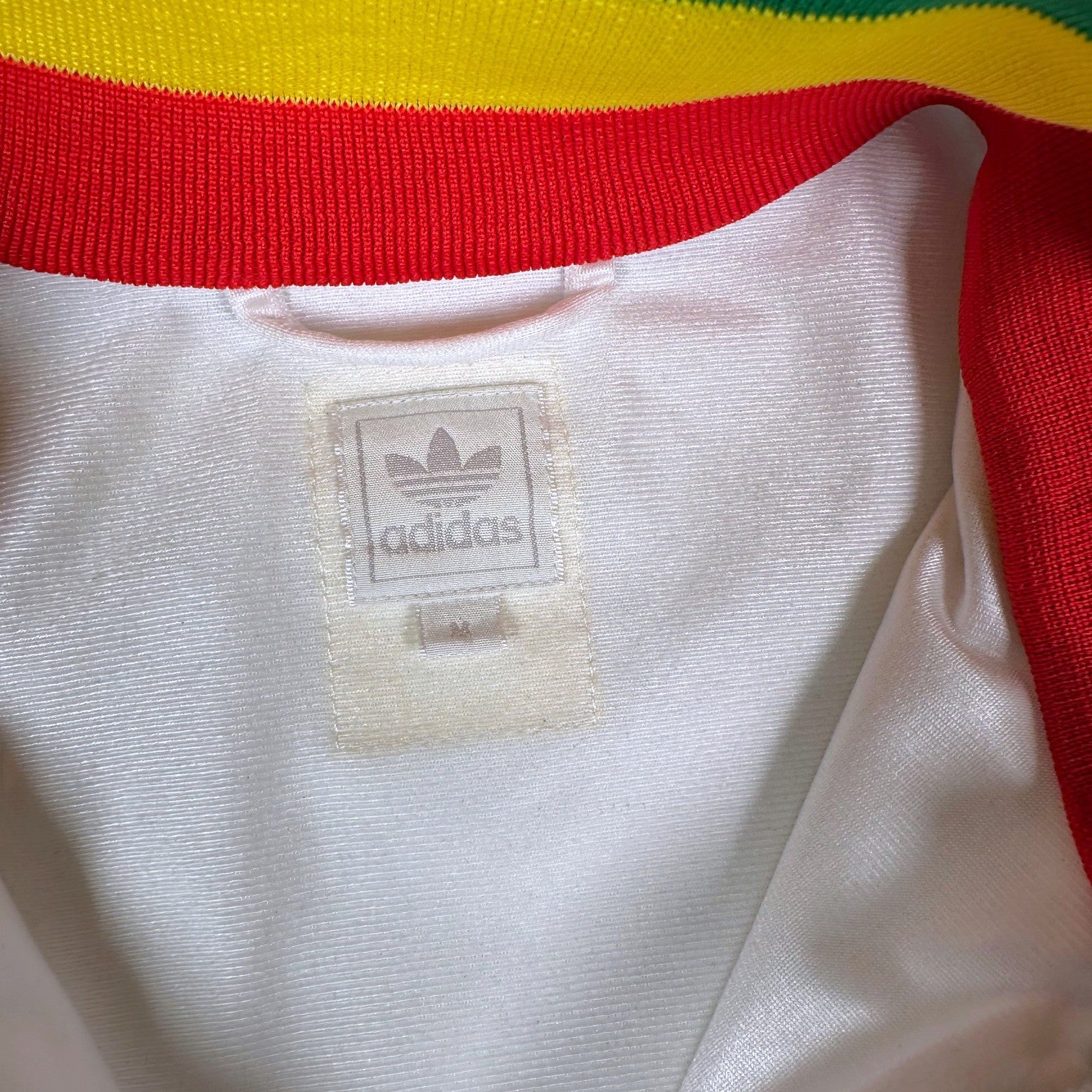 Digg It Thrift & Vintage Adidas Chile Rasta track jacket label showing white fabric with red and yellow collar trim
