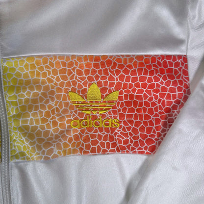 Digg It Thrift & Vintage Adidas Chile track jacket featuring a white base and yellow-to-red Rasta mosaic logo detail