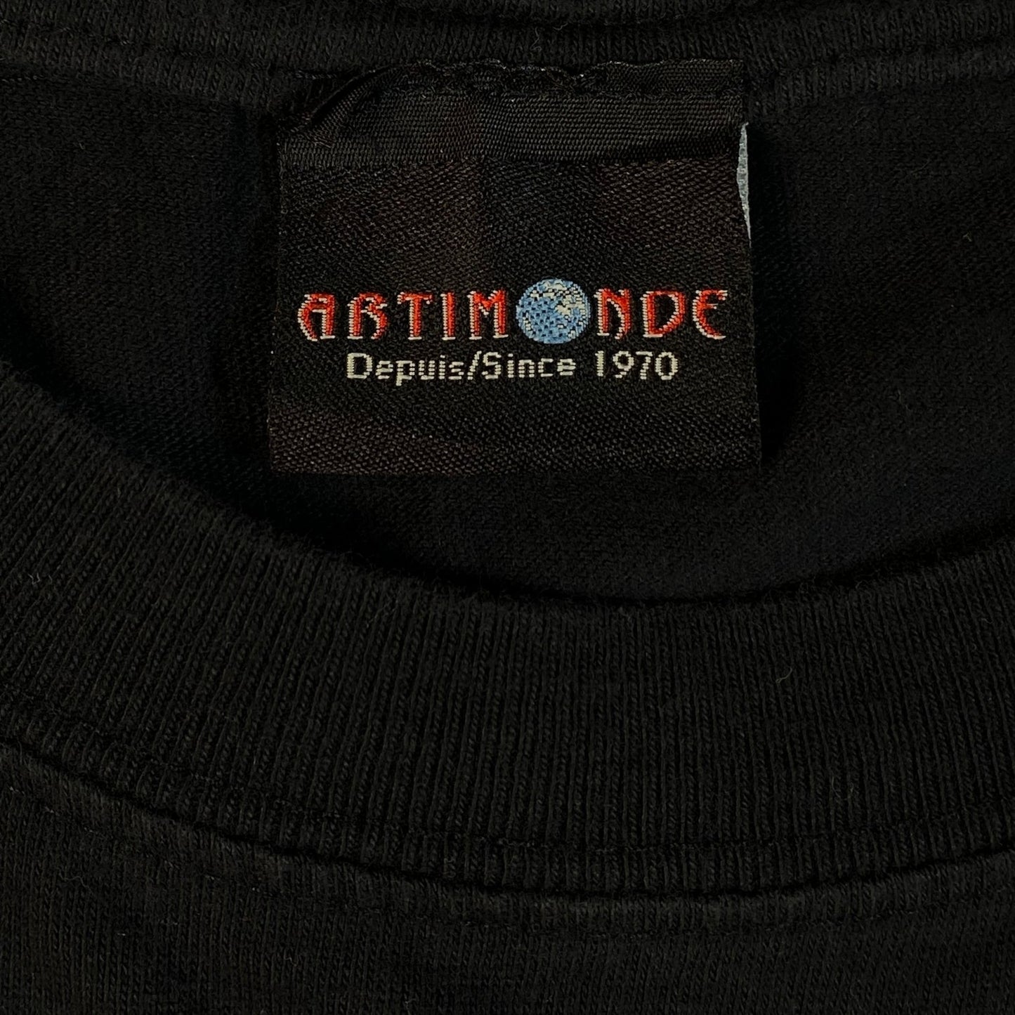 Digg It Thrift & Vintage black t-shirt neck label featuring the Artimonde brand logo