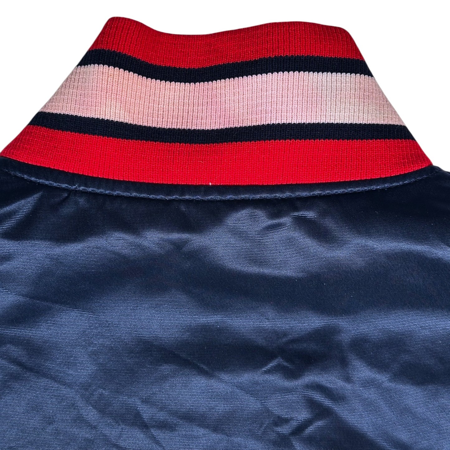 Digg It Thrift & Vintage Starter Atlanta Braves satin bomber jacket collar with red, white, and navy striped trim.