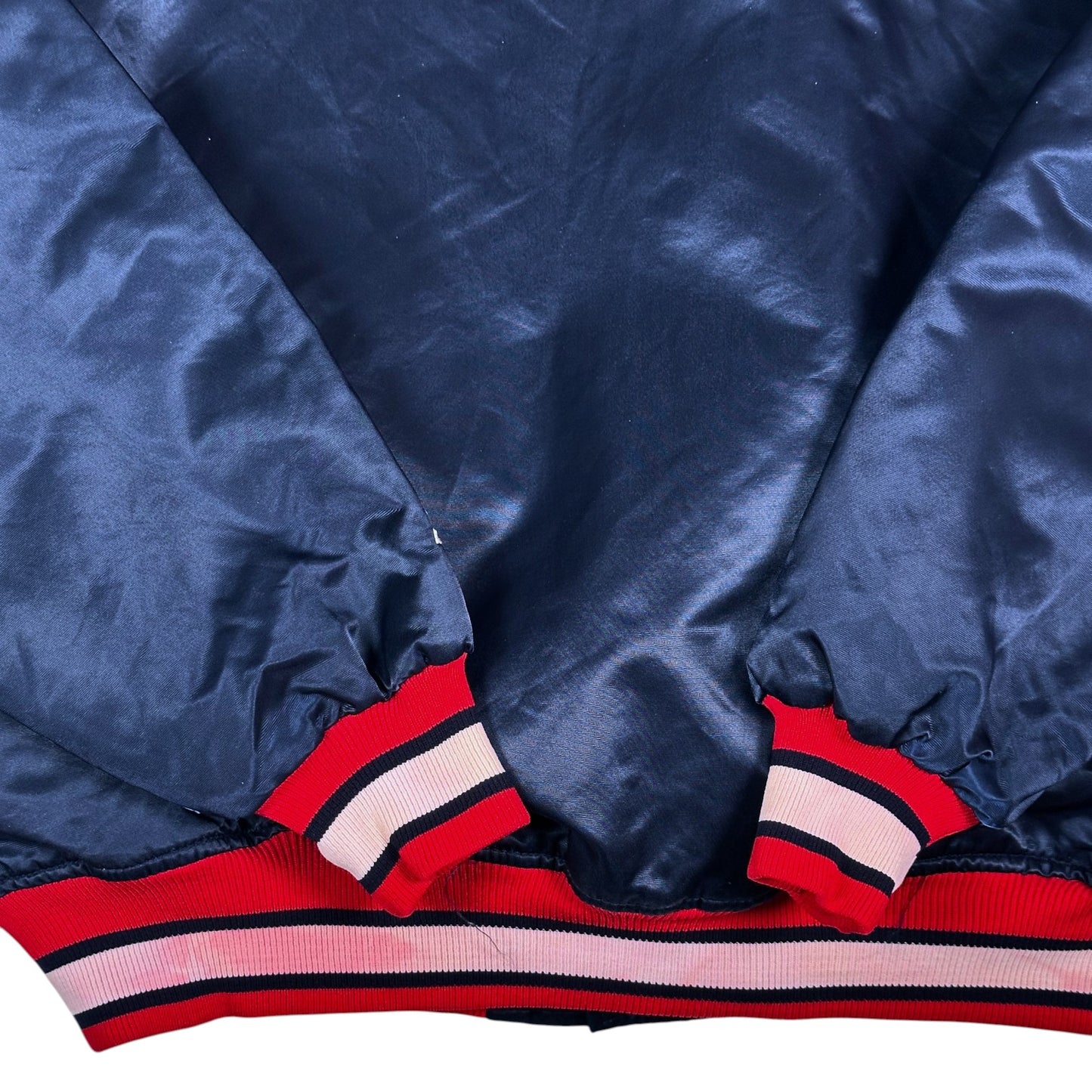 Digg It Thrift & Vintage navy blue satin Atlanta Braves bomber jacket with red and white striped ribbed cuffs