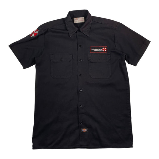 Digg It Thrift & Vintage black Dickies short sleeve work shirt with Umbrella Corporation patches on chest and sleeve.