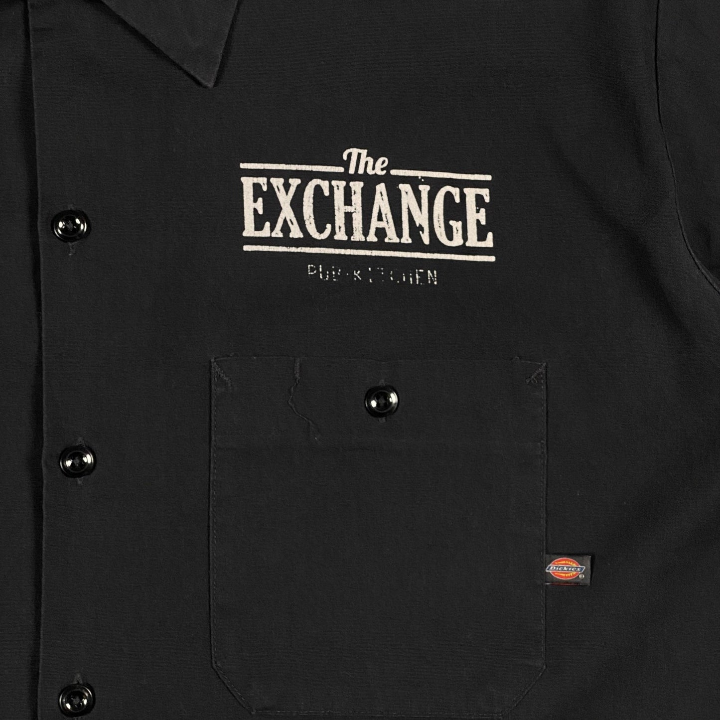 Digg It Thrift & Vintage black Dickies work shirt featuring The Exchange Pub + Kitchen logo and a front chest pocket.