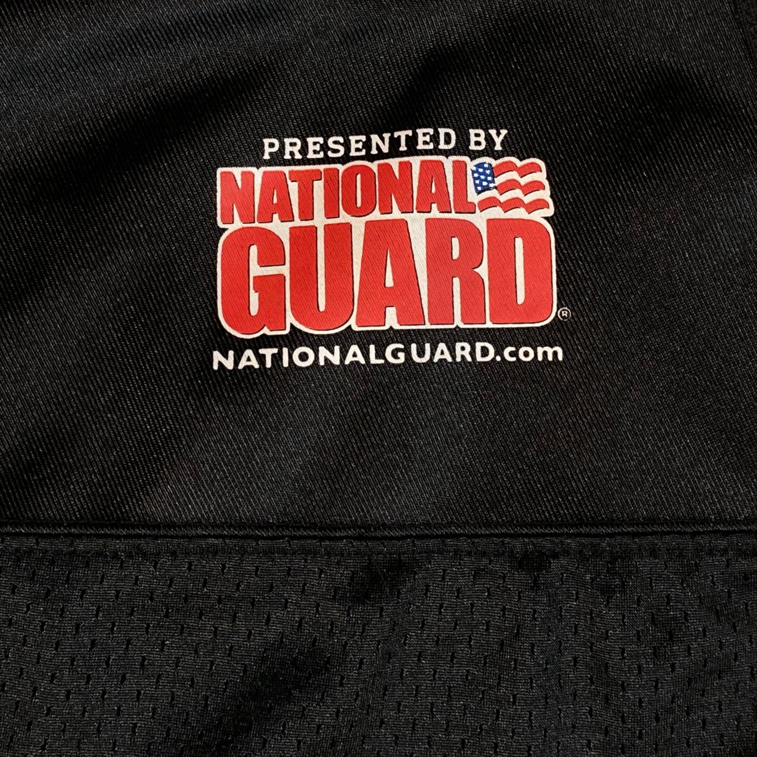 Digg It Thrift & Vintage black mesh NFL H.S.P.D. practice jersey featuring a National Guard logo print