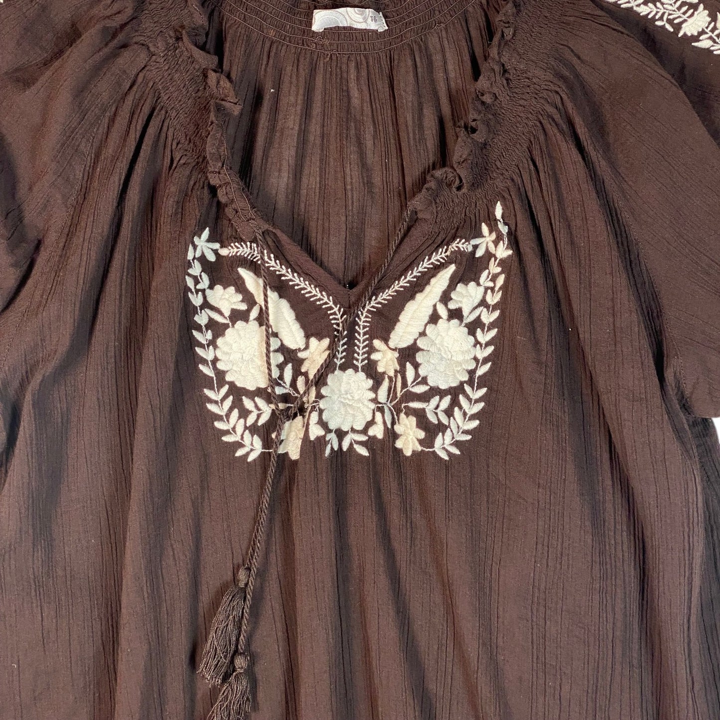 Digg It Thrift & Vintage brown peasant top with white floral embroidery, v-neckline, and tassel tie, size XL fit