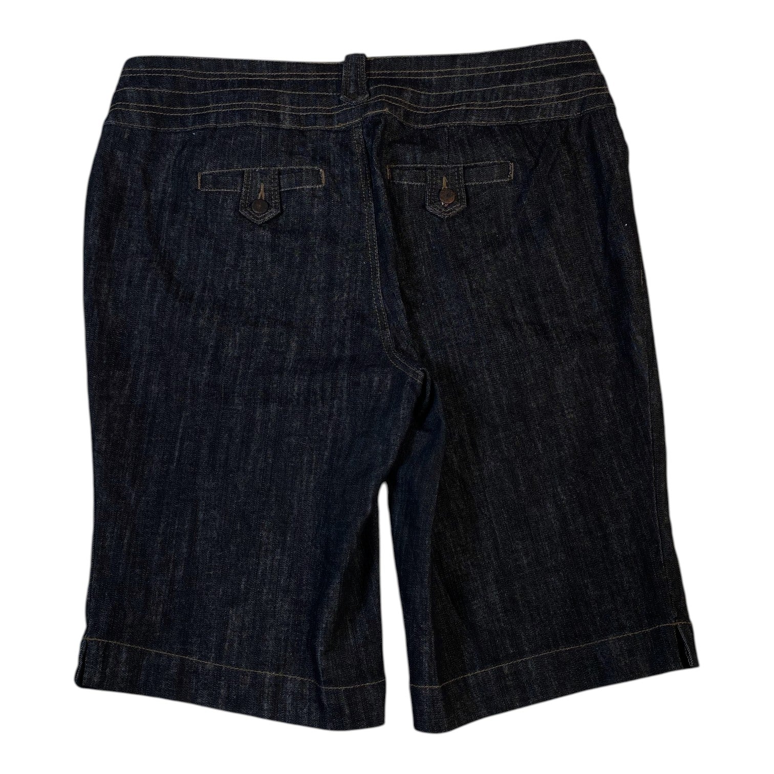 Back view of Digg It Thrift & Vintage dark wash denim shorts with buttoned flap pockets and contrast stitching.