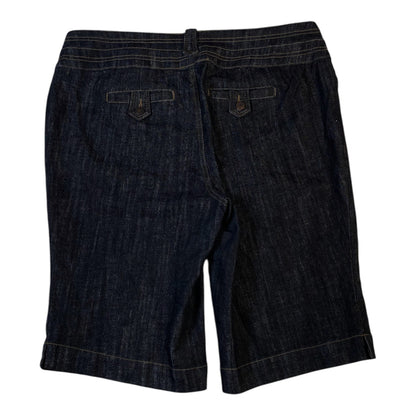 Back view of Digg It Thrift & Vintage dark wash denim shorts with buttoned flap pockets and contrast stitching.