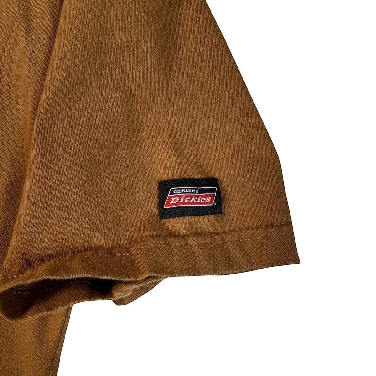 Digg It Thrift & Vintage beige Dickies t-shirt sleeve featuring the iconic red and white brand logo patch