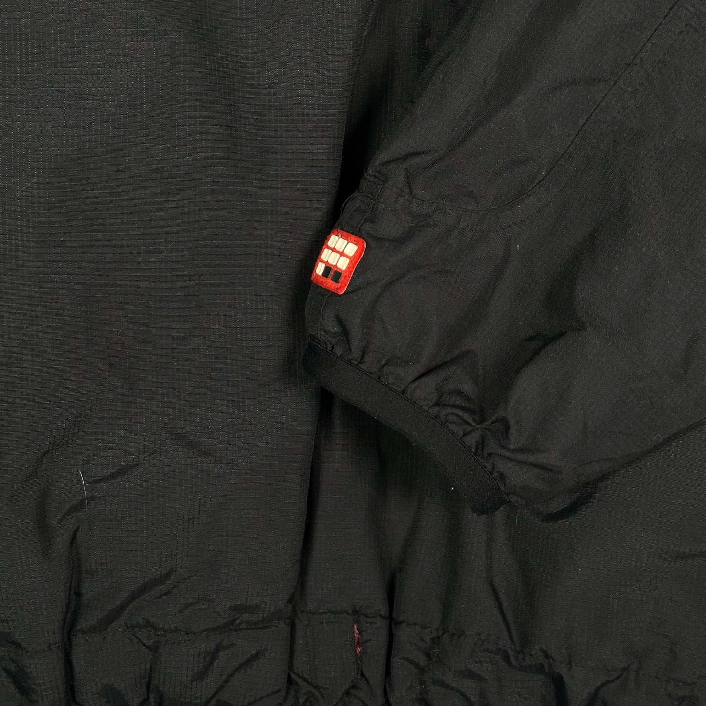 Digg It Thrift & Vintage black Ecko Unltd. winter jacket sleeve detail with red logo patch and fleece lining