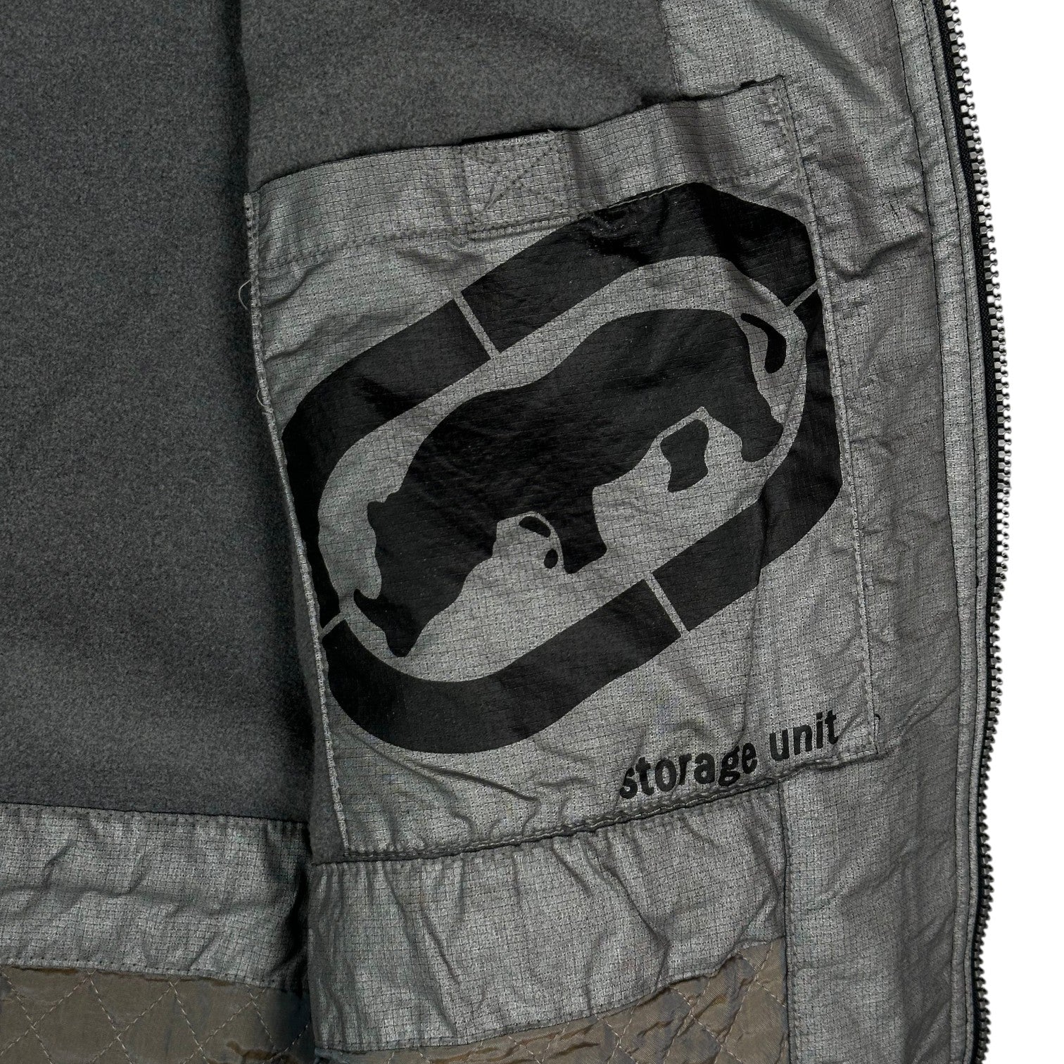 Digg It Thrift & Vintage black Ecko Unltd. winter jacket interior featuring a fleece lining and storage unit pocket