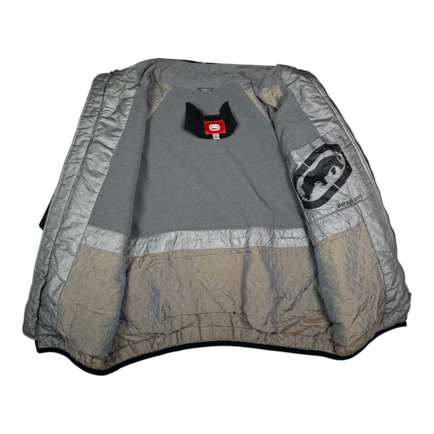 Interior view of a Digg It Thrift & Vintage Ecko Unltd. black winter jacket with grey fleece lining and branding.