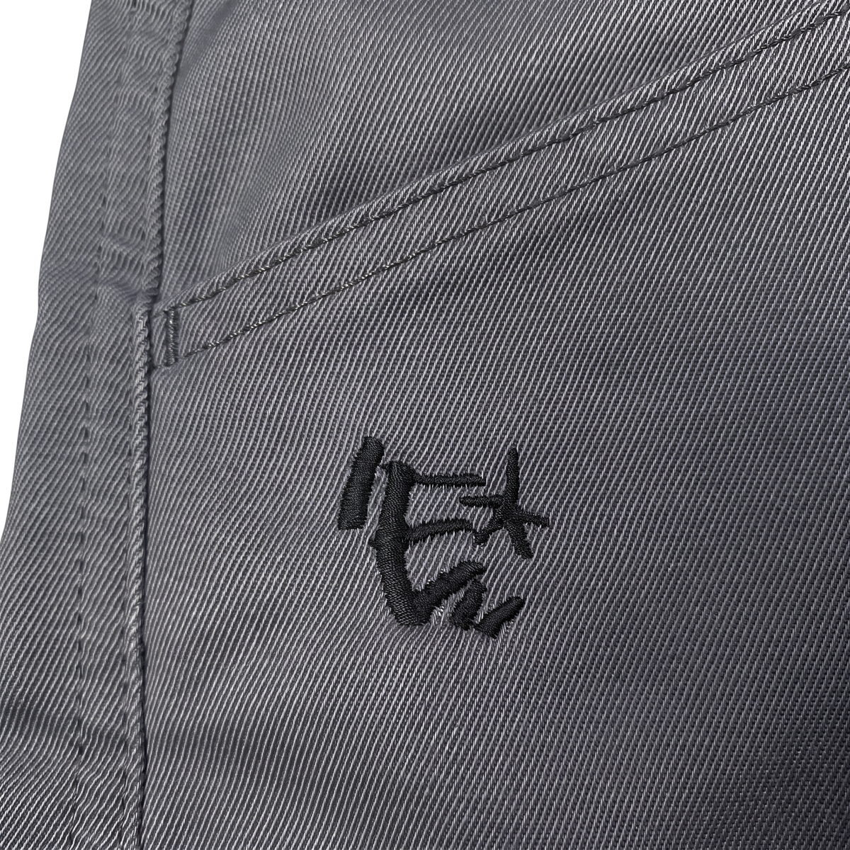 Digg It Thrift & Vintage Energie B-Boy grey denim jorts featuring a detailed black embroidered logo on the pocket.