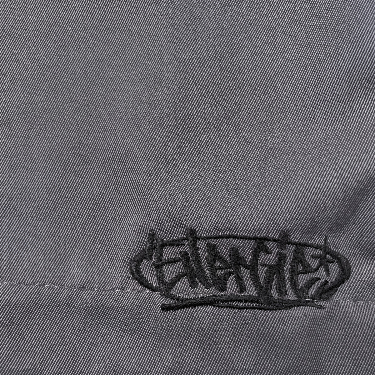 Digg It Thrift & Vintage grey denim fabric featuring black embroidered Energie logo detail on B-Boy hip hop jorts