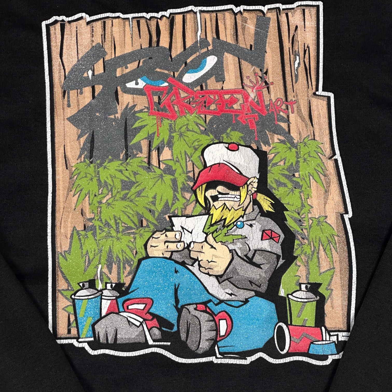Digg It Thrift & Vintage black pullover hoodie featuring a colorful graffiti art character print with spray cans.