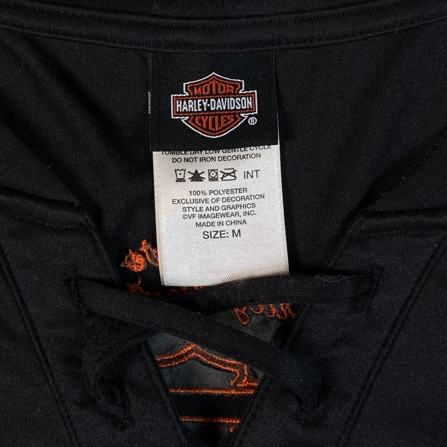 Digg It Thrift & Vintage black Harley-Davidson lace-up football jersey tag showing size medium and polyester material