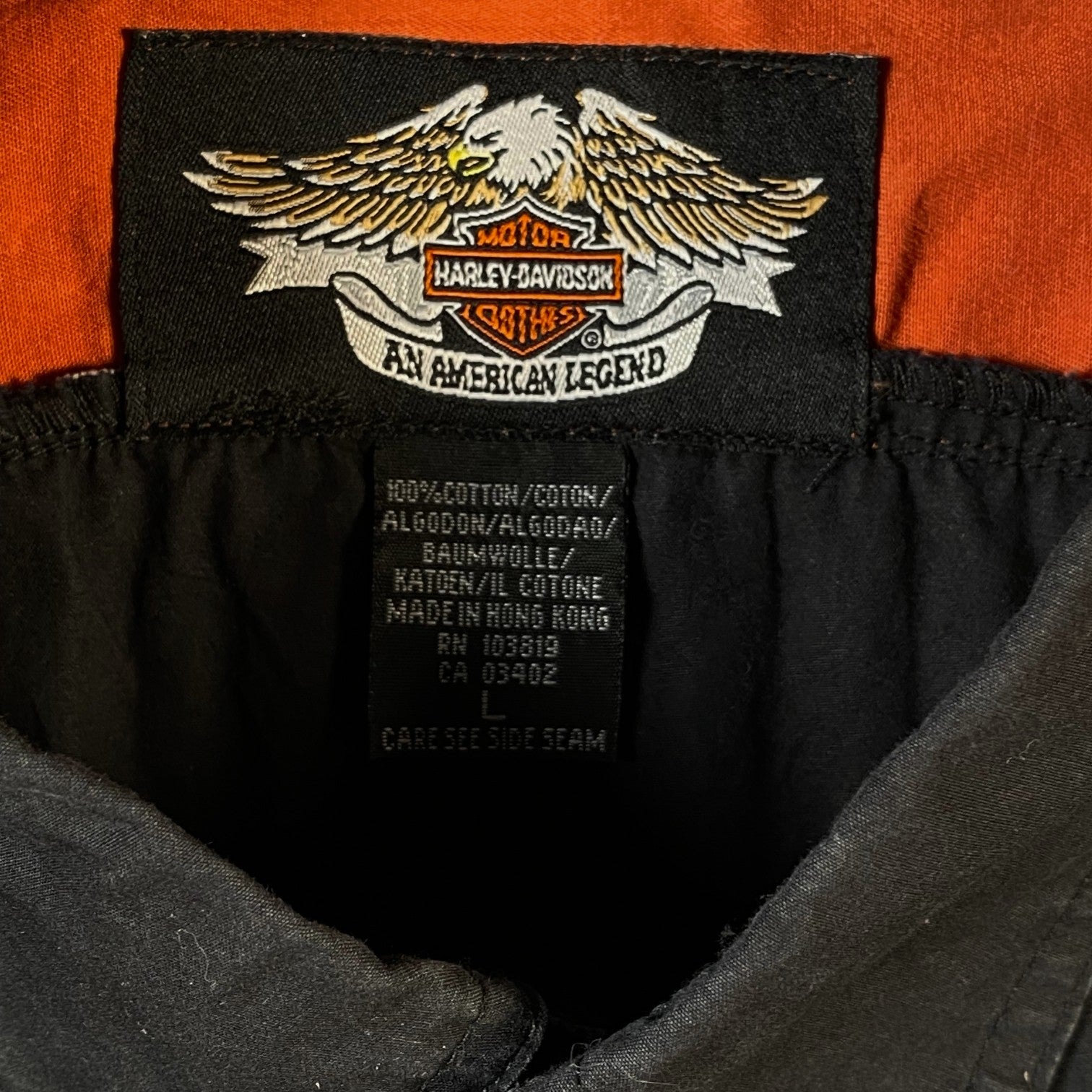 Digg It Thrift & Vintage Harley-Davidson embroidered logo on a black and orange cotton mechanic shirt label