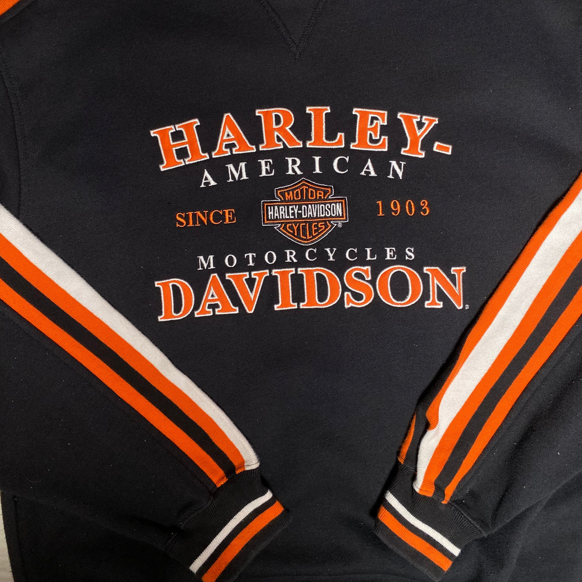 Digg It Thrift & Vintage black Harley-Davidson crewneck sweatshirt with orange and white striped sleeves