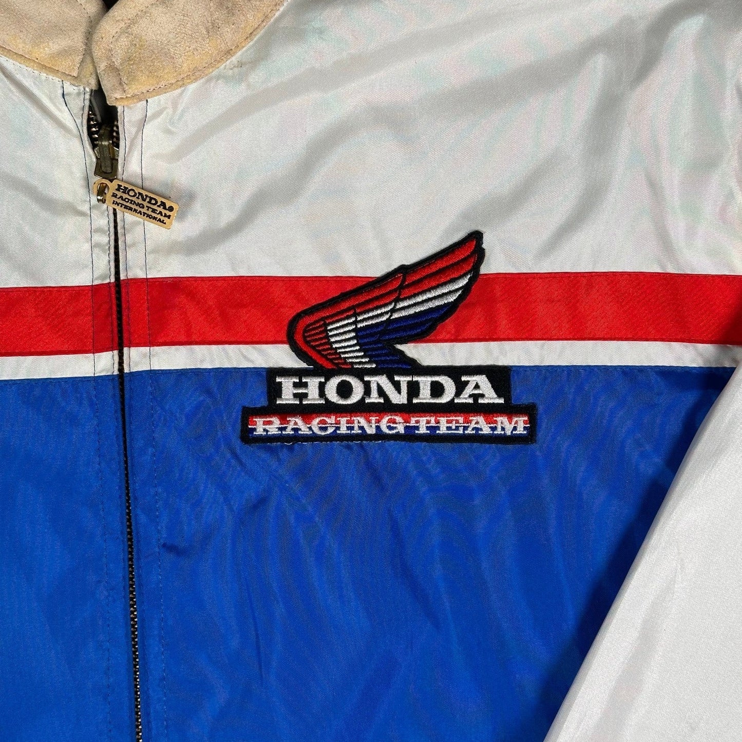 Digg It Thrift & Vintage reversible Honda Racing Team windbreaker jacket with red, white, and blue racing stripes.