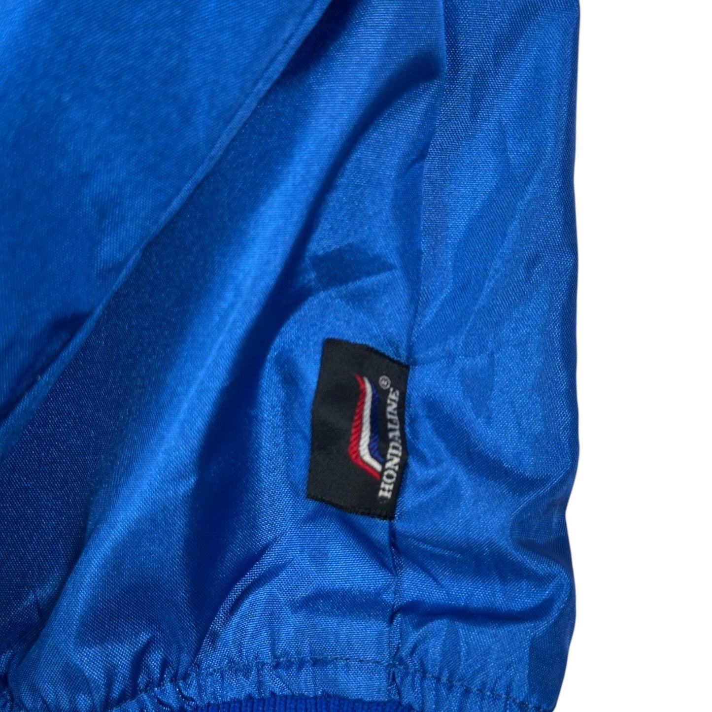 Digg It Thrift & Vintage blue nylon windbreaker jacket featuring a Hondaline logo tag detail.