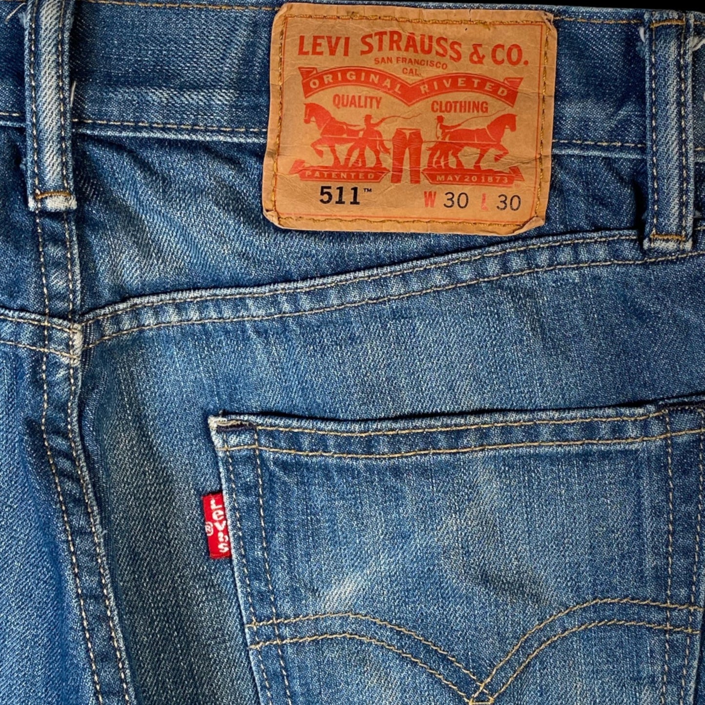 Digg It Thrift & Vintage Levi’s 511 slim fit denim jorts with raw hem and classic leather back patch