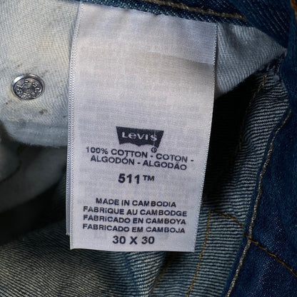 Digg It Thrift & Vintage Levi's 511 slim fit denim jorts care tag showing 100 percent cotton and size 30x30
