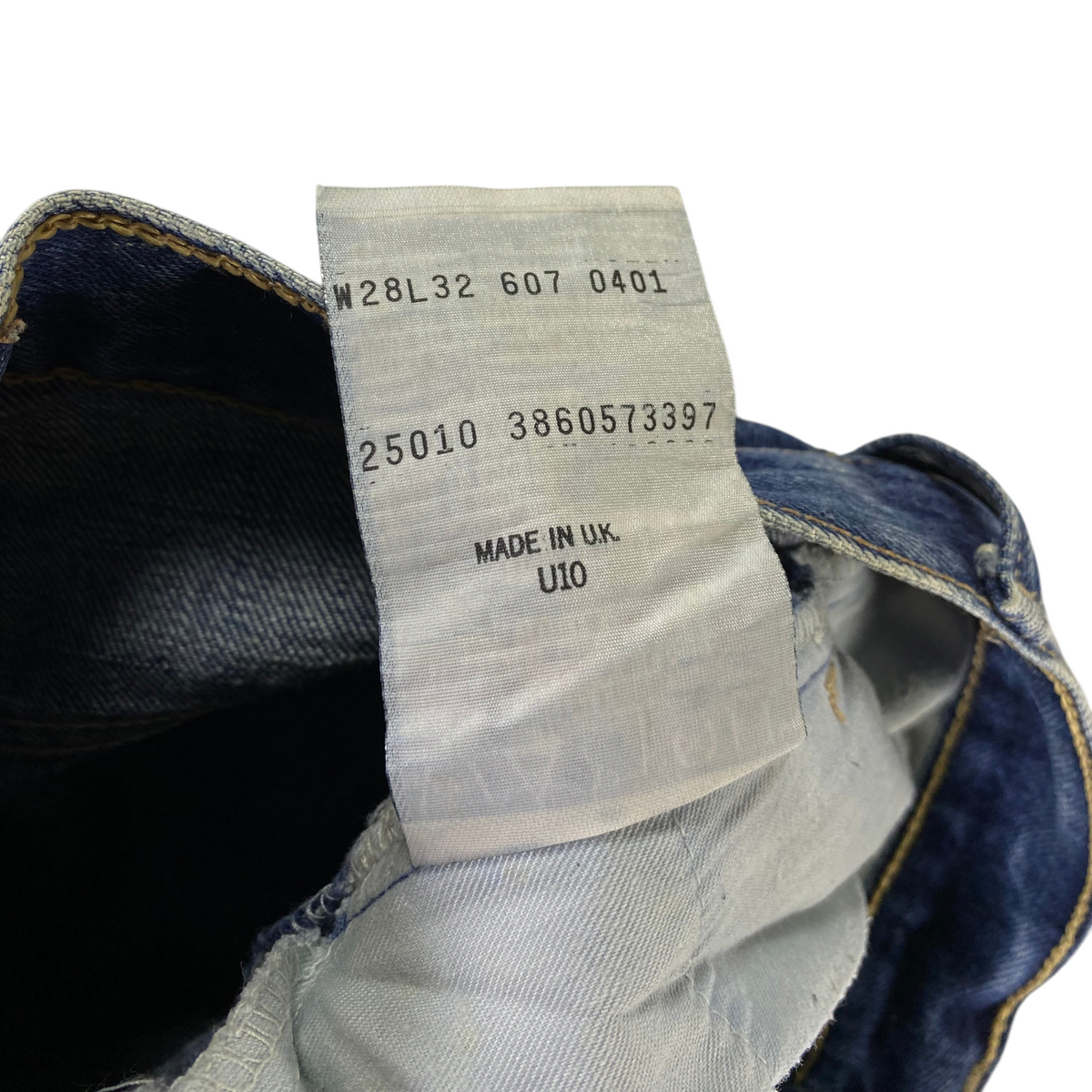 Digg It Thrift & Vintage Levi's 607 slim straight jeans interior care tag showing size 28x32 and Made in UK label.