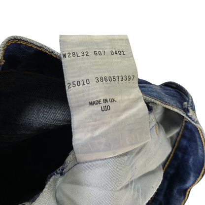Digg It Thrift & Vintage Levi's 607 slim straight jeans interior care tag showing size 28x32 and Made in UK label.