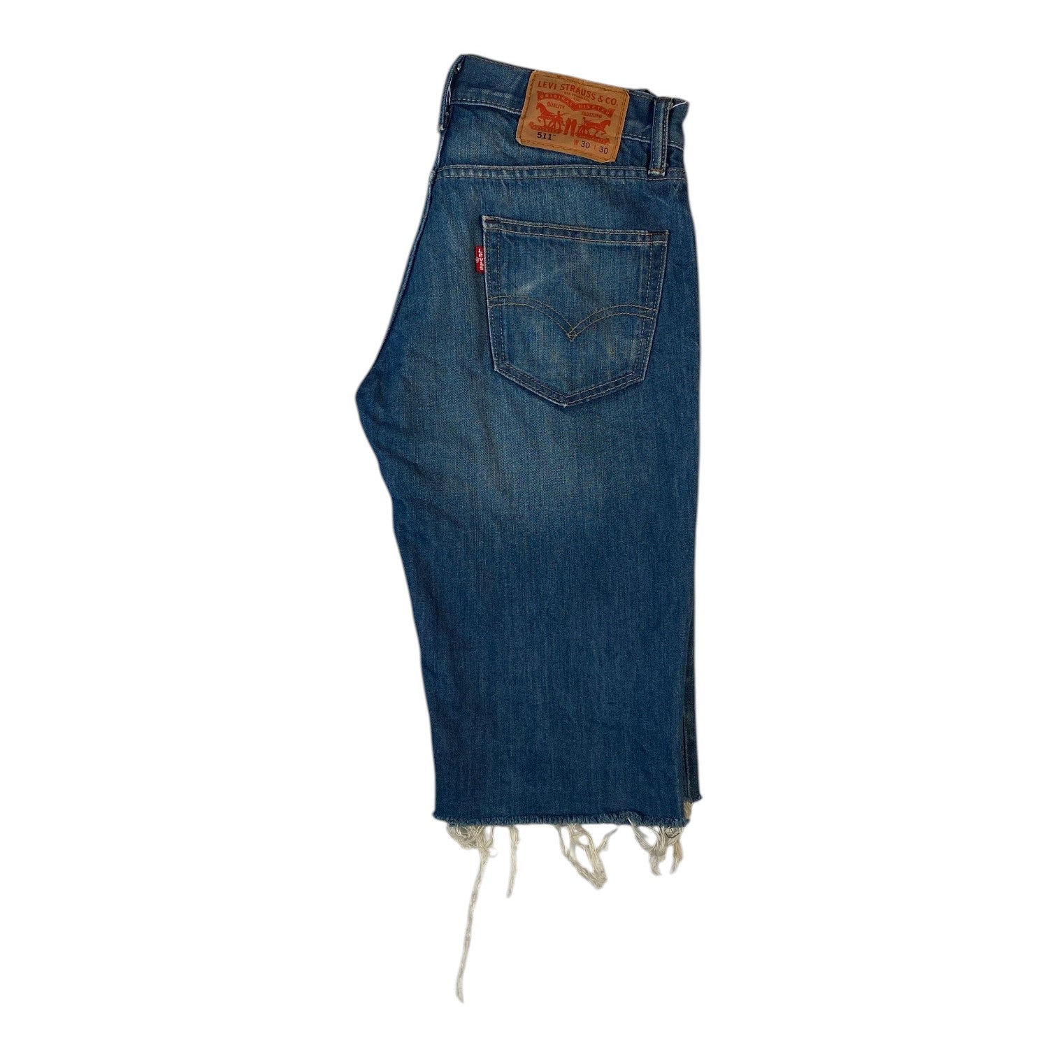 Digg It Thrift & Vintage Levi’s 511 slim fit denim jorts in blue with a raw frayed hem and leather back patch