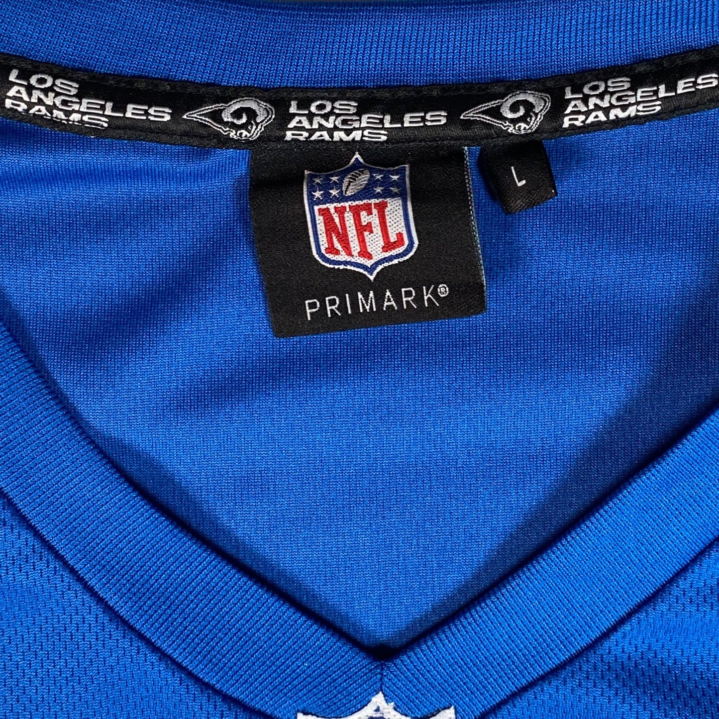 Digg It Thrift & Vintage blue NFL Los Angeles Rams jersey with V-neck collar and size large tag