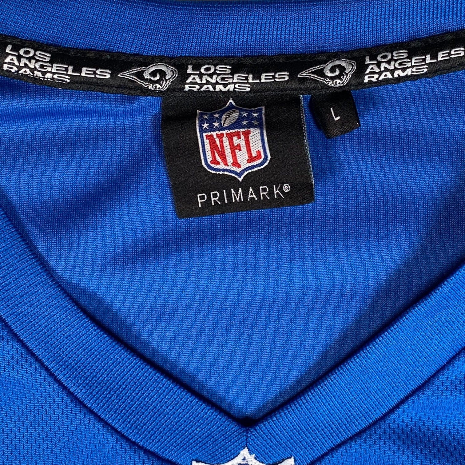 Digg It Thrift & Vintage blue NFL Los Angeles Rams jersey with V-neck collar and size large tag