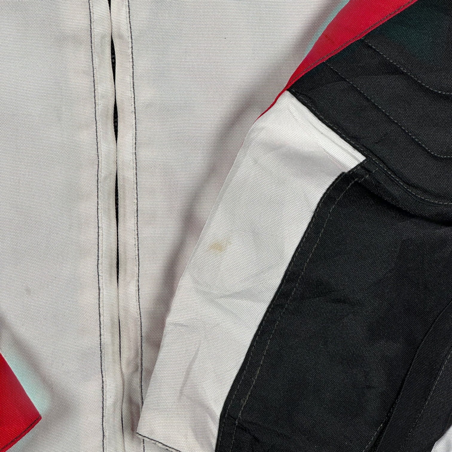 Digg It Thrift & Vintage Louis 75th Anniversary motorcycle racing jacket in white, red, and black textile fabric