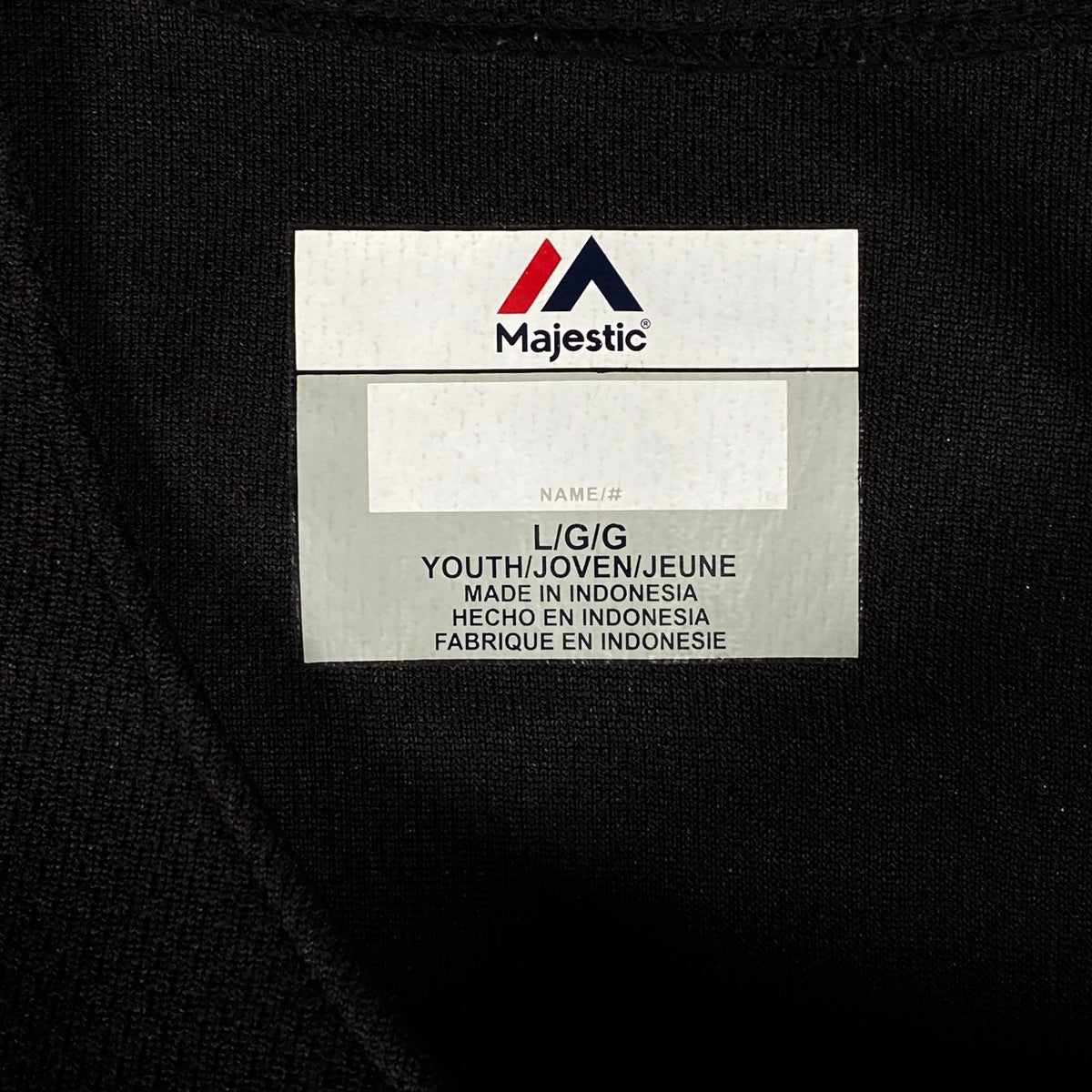 Digg It Thrift & Vintage Majestic Cool Base youth large baseball jersey neck label on black fabric