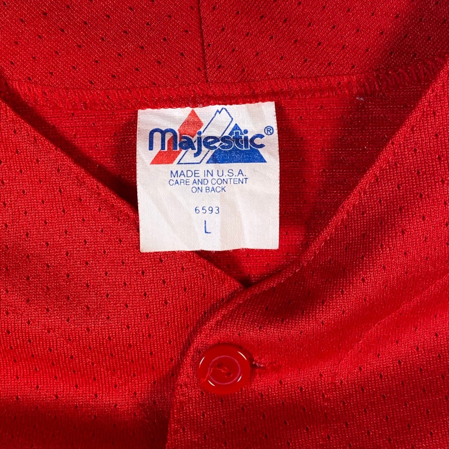 Digg It Thrift & Vintage red Majestic baseball jersey tag showing size large and made in USA label
