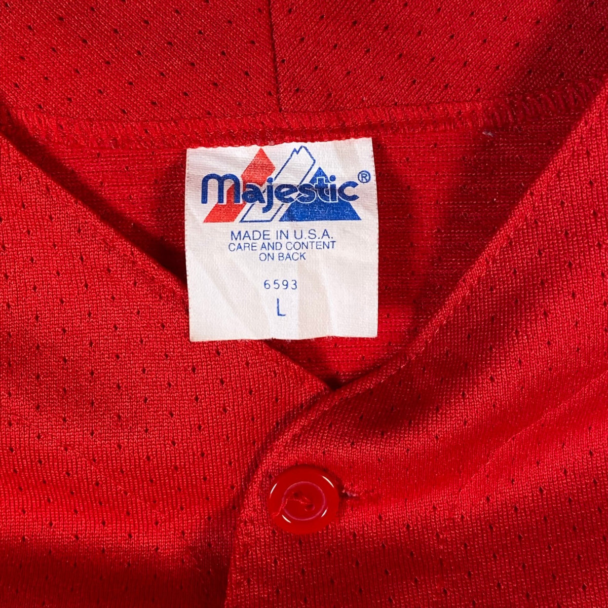Digg It Thrift & Vintage red Majestic baseball jersey tag showing size large and made in USA label