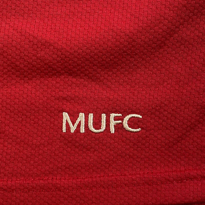 Digg It Thrift & Vintage 2006-2007 Manchester United home shirt detail with embroidered white MUFC logo on red fabric