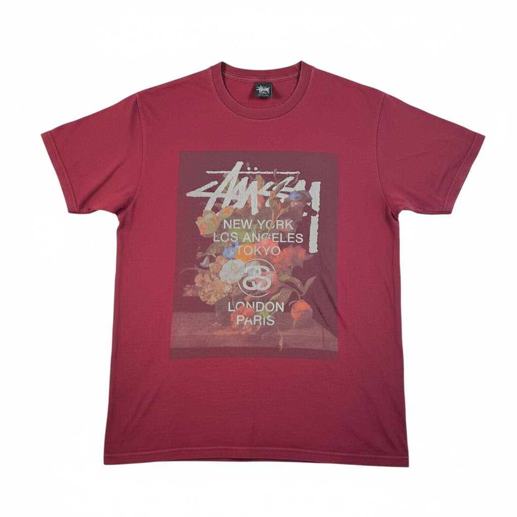 Digg It Thrift & Vintage maroon Stüssy World Tour t-shirt featuring a floral painting graphic print on the front.