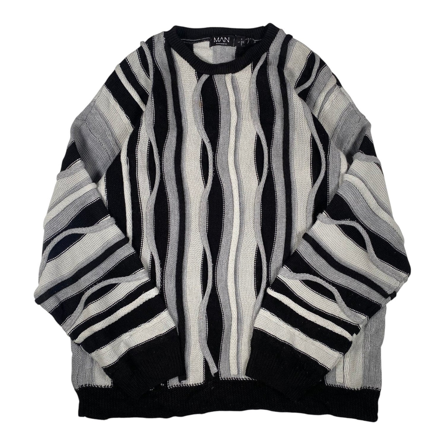 Digg It Thrift & Vintage boohooMAN monochromatic wavy cable knit crewneck sweater in black, grey, and white.