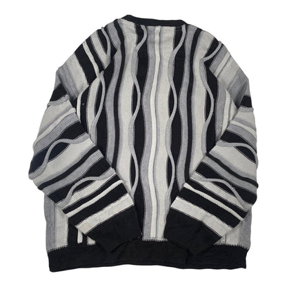 Digg It Thrift & Vintage boohooMAN monochromatic wavy cable knit sweater with black, grey, and white vertical stripes.