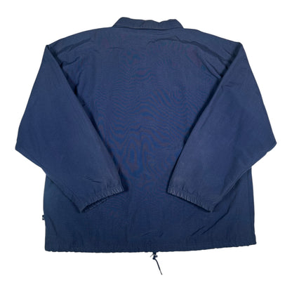 Back view of a navy blue Adidas coach jacket from Digg It Thrift & Vintage with a drawstring hem and elastic cuffs.