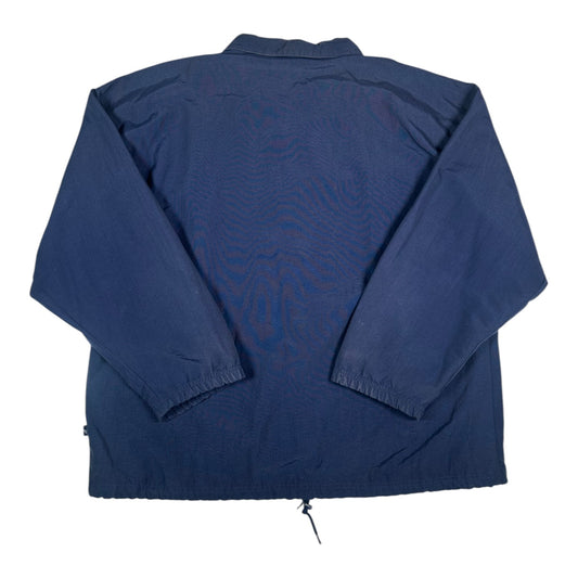 Back view of a navy blue Adidas coach jacket from Digg It Thrift & Vintage with a drawstring hem and elastic cuffs.
