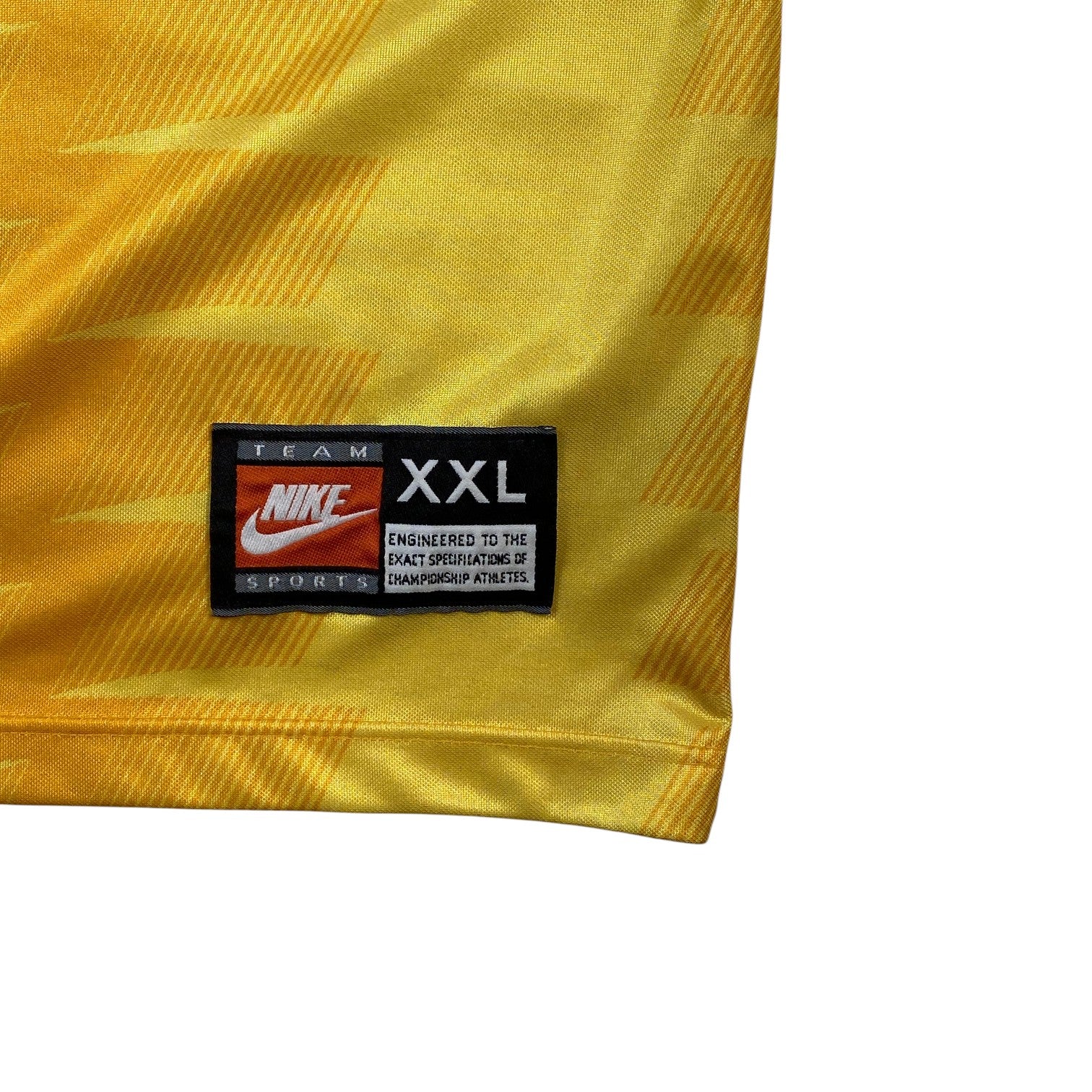 Digg It Thrift & Vintage yellow Nike Team Sports jersey tag showing XXL size on a 90s football shirt