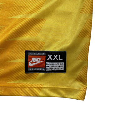 Digg It Thrift & Vintage yellow Nike Team Sports jersey tag showing XXL size on a 90s football shirt
