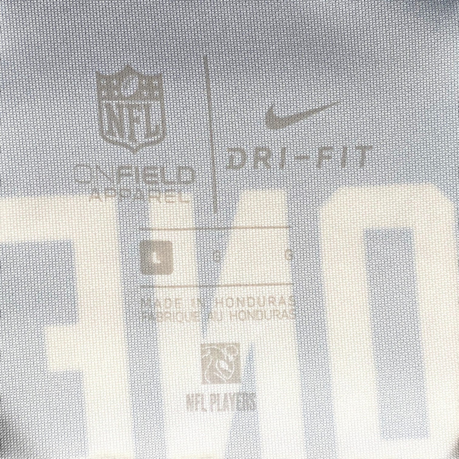 Digg It Thrift & Vintage Nike On Field NFL jersey interior tag showing size Large and Dri-Fit technology details