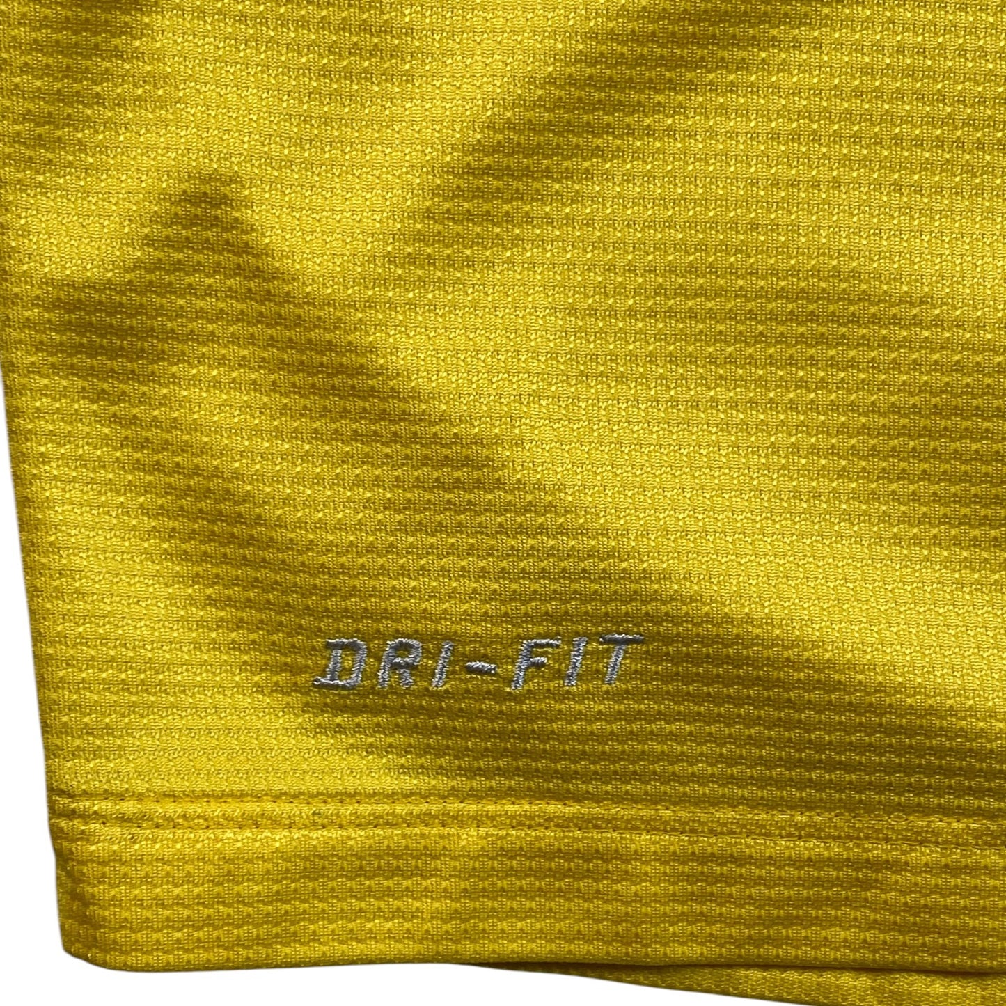 Digg It Thrift & Vintage yellow Nike Dri-FIT textured fabric detail from a 2013-2014 Arsenal football shirt
