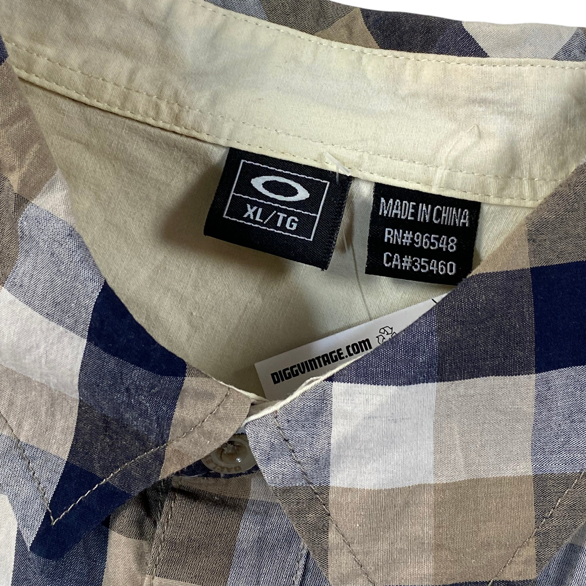 Digg It Thrift & Vintage Oakley beige and navy plaid short sleeve button up shirt collar and size XL tag